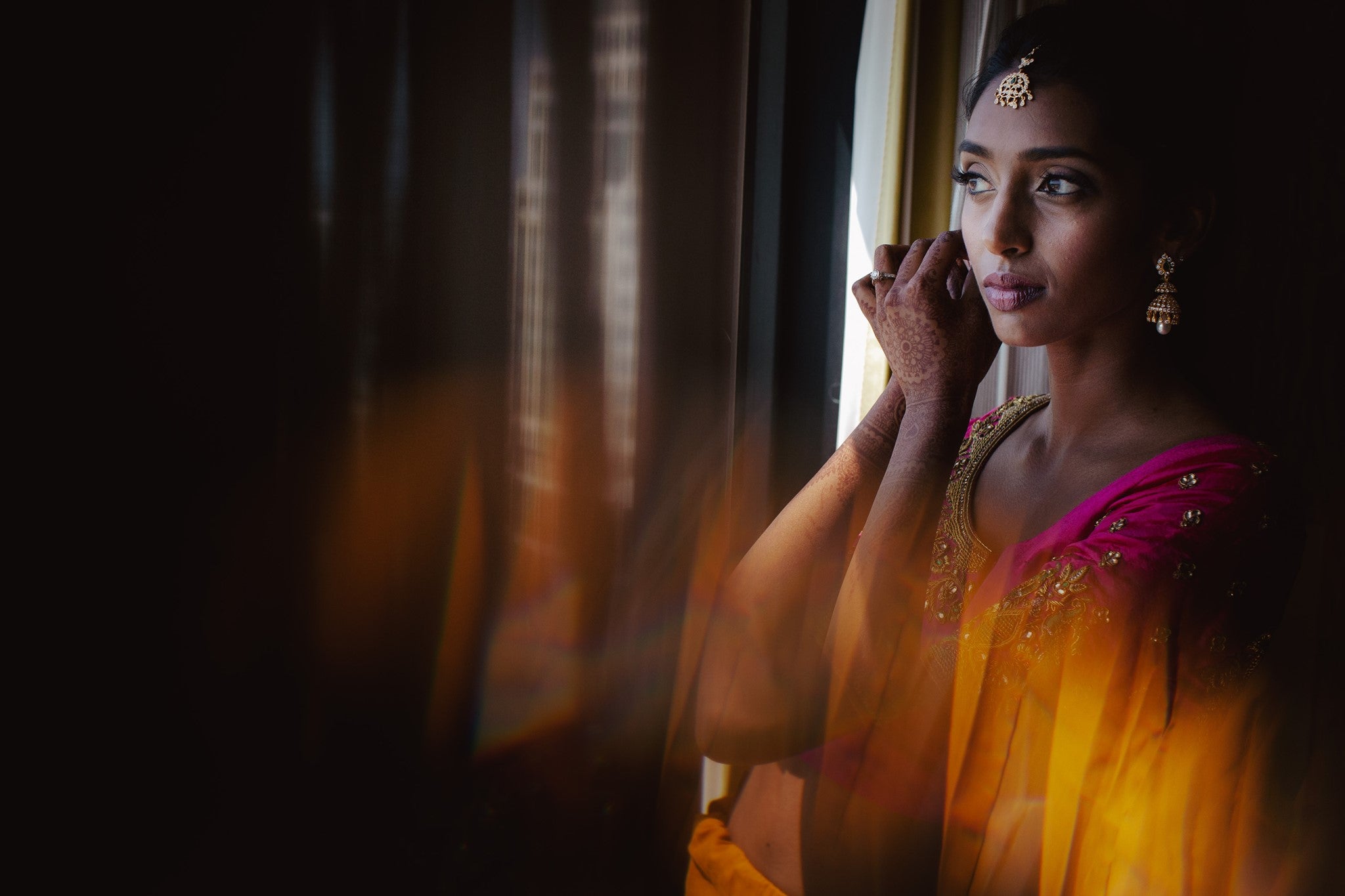 A portrait of an Indian bride wearing her earrings