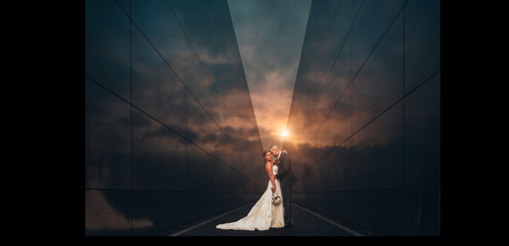 A bride and groom posing during sunset as the sun peeks from the building's corner