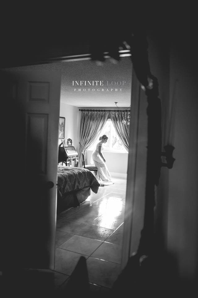 a black and white image of bride getting ready