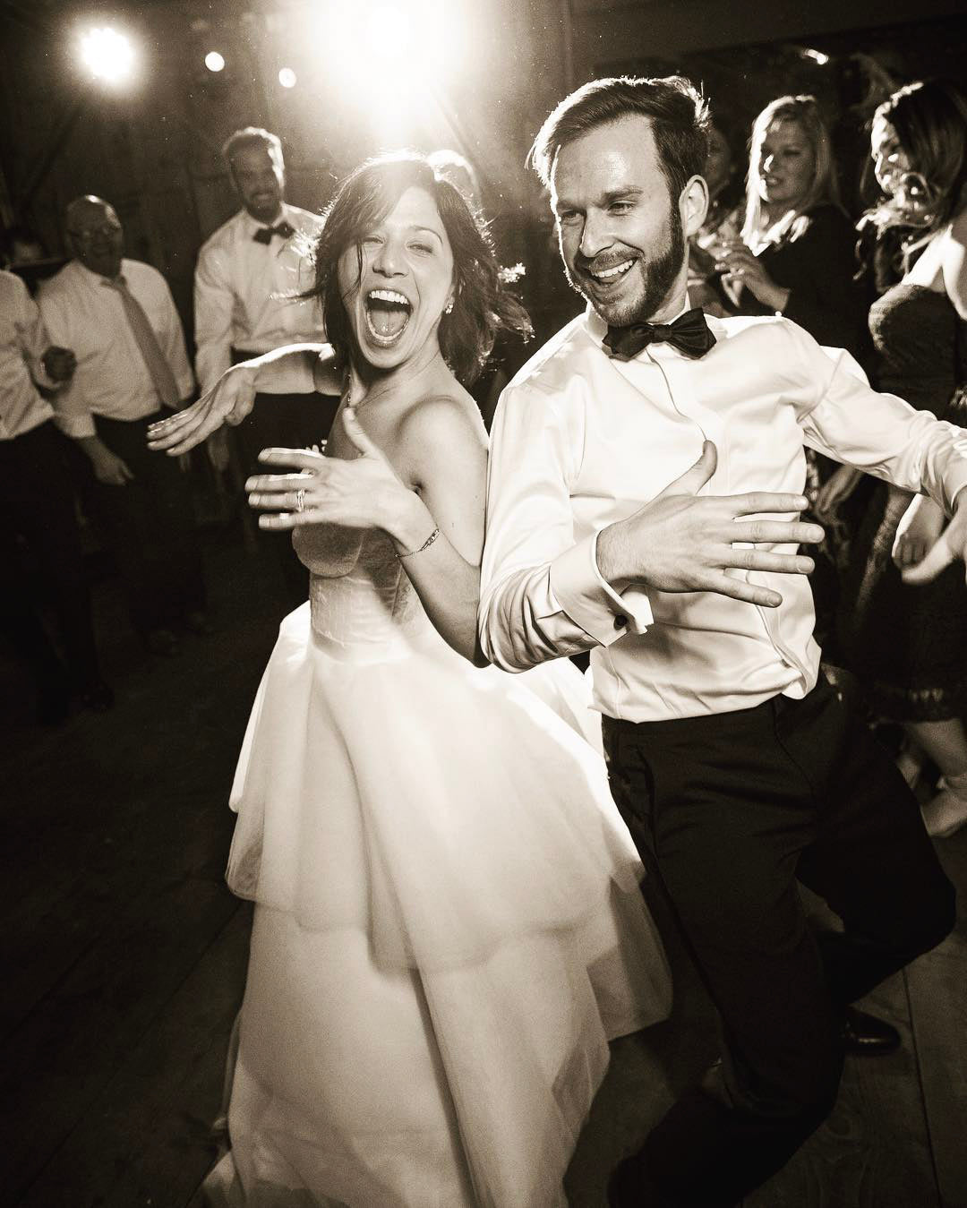 a wedding couple dancing and having fun with everyone