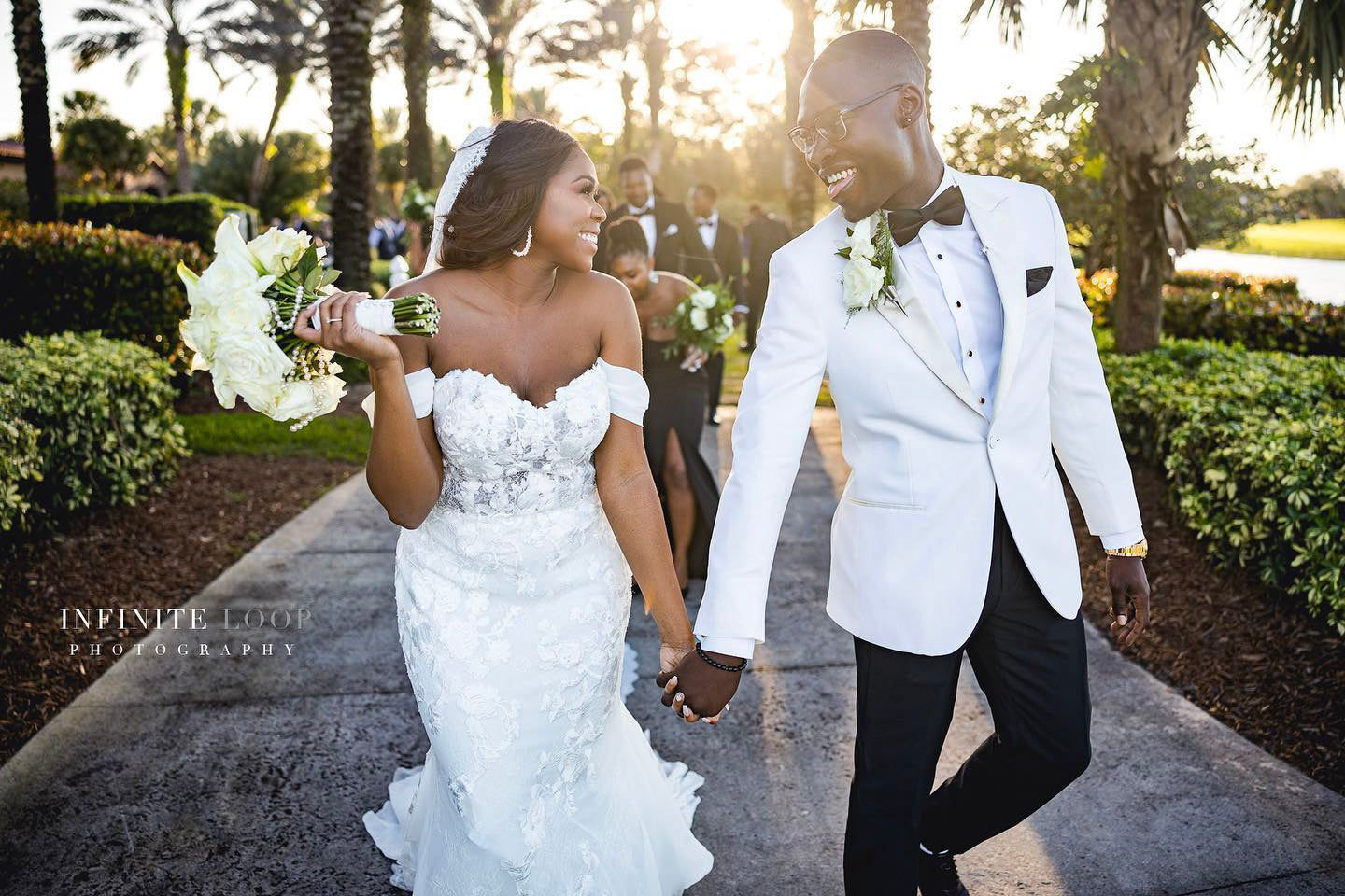 a wedding couple looking at each other and laughing during their grand wedding exit