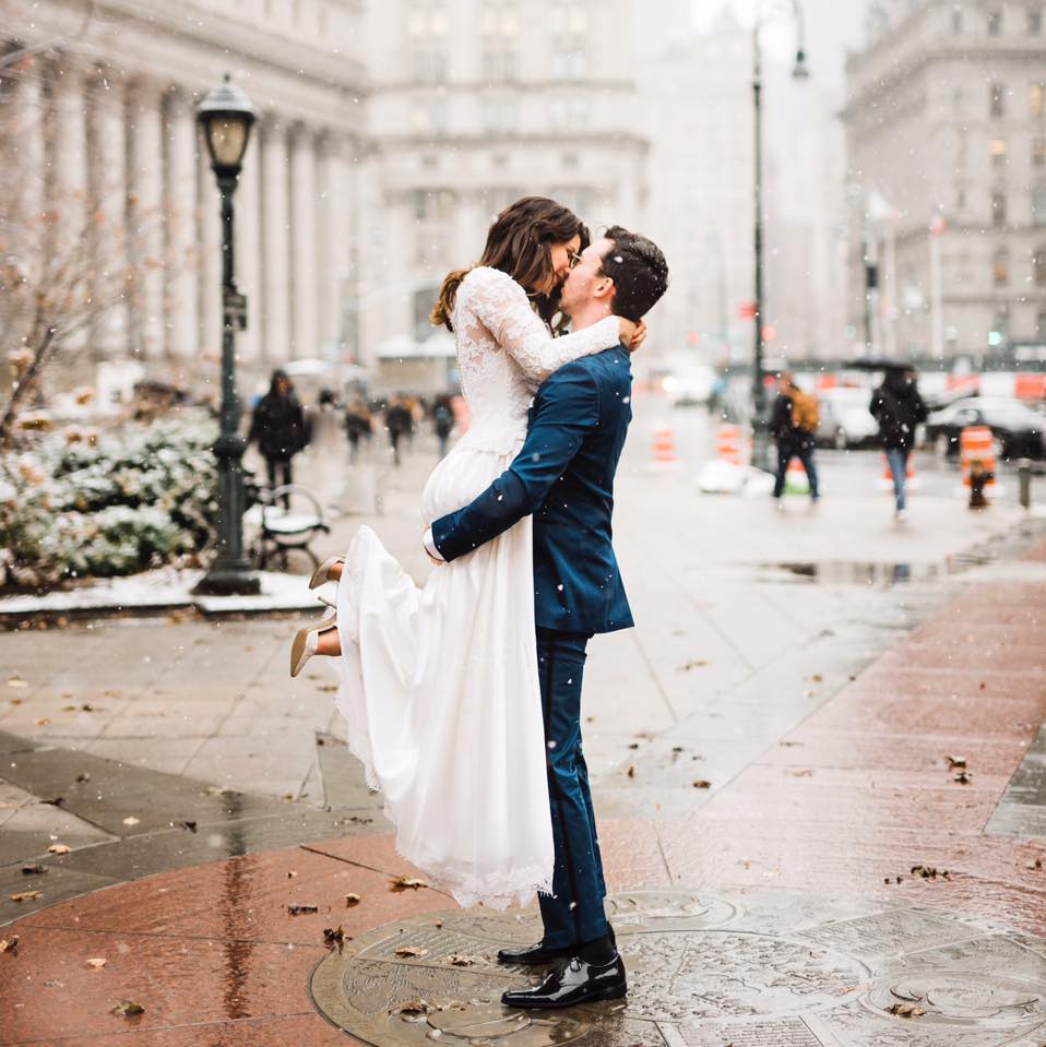 a wedding couple shares an intimate moment in the street