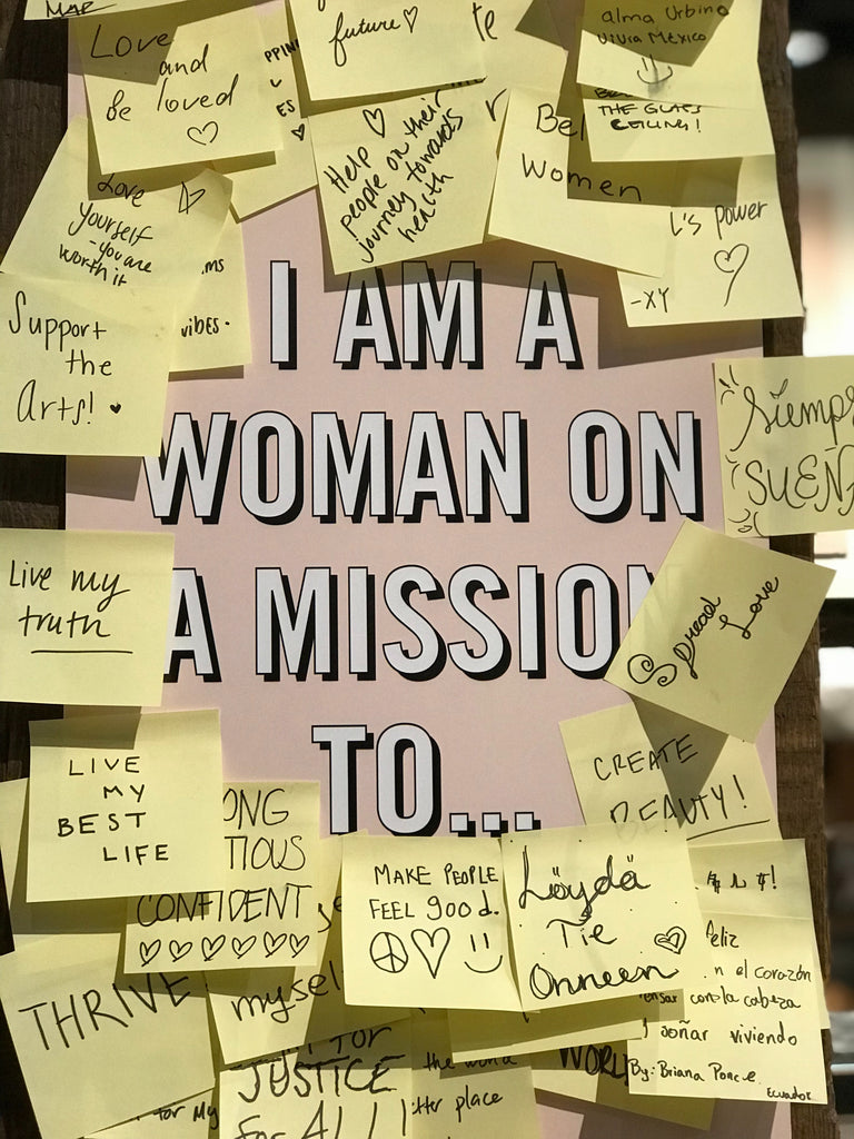 text that says i am a woman on a mission to... surrounded by post it notes of different goals