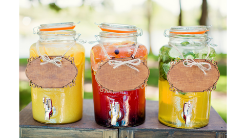 3 cold tea jars with dispensers on them to serve tea to people.