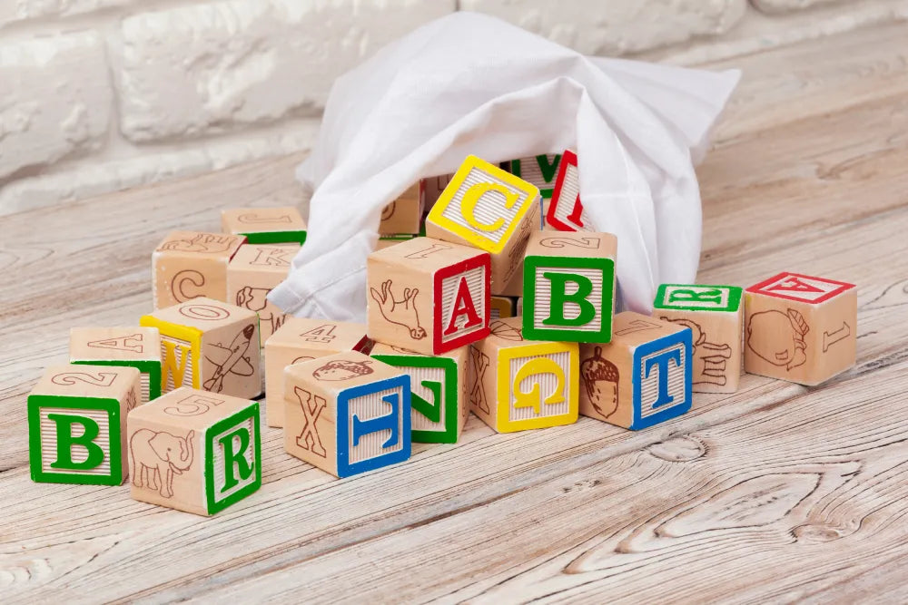 multicolored-wooden-toy-blocks-wooden-table.webp__PID:4c4449ee-1211-4fab-a979-8f667df775ef
