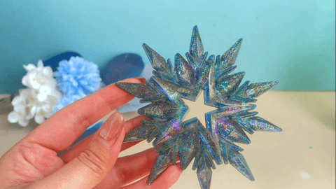 dark green iridescent snowflake is out of the mold