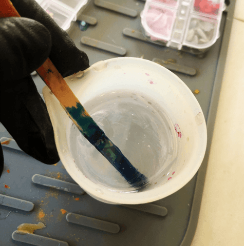 Mix enough warmed, 2-part epoxy resin to fill your pen molds