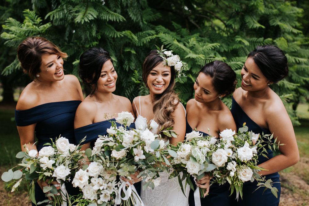 happy bride with flowers and bridesmaids fernbank farm wedding