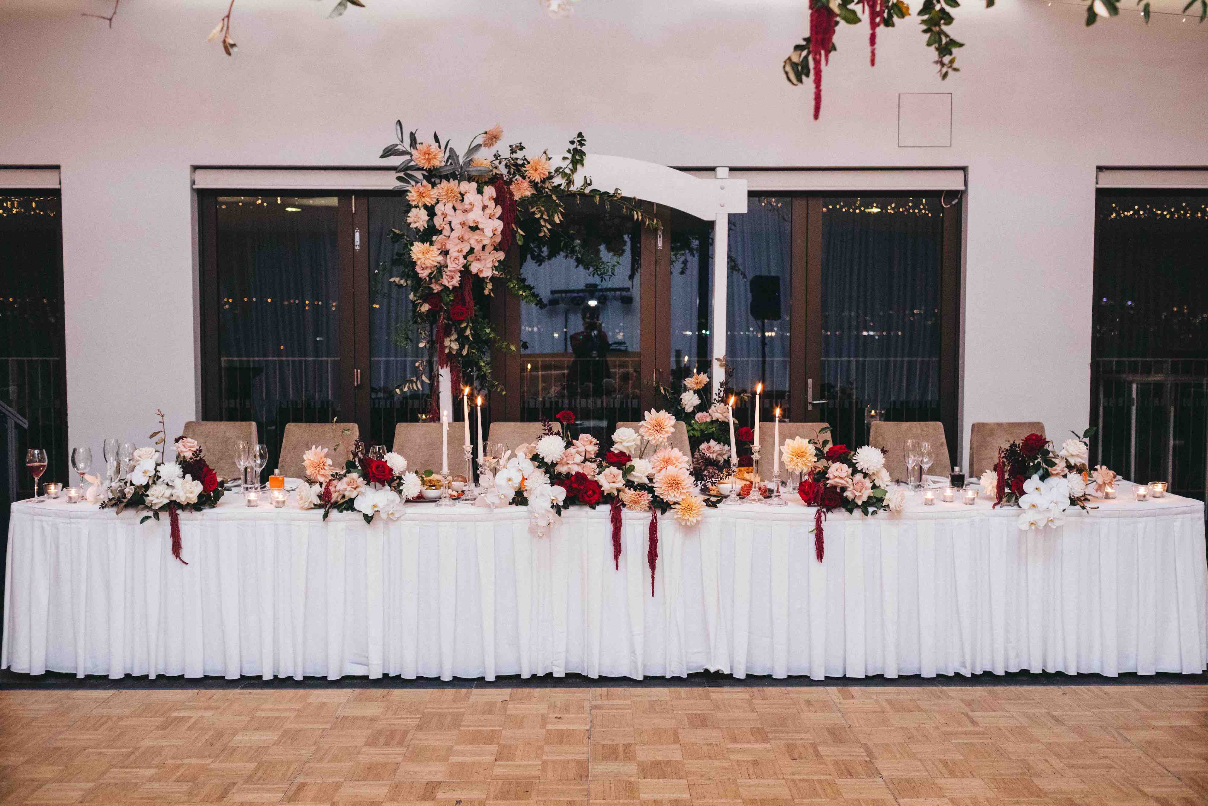 bridal table with backdrop flower arch inside sergeants mess wedding reception