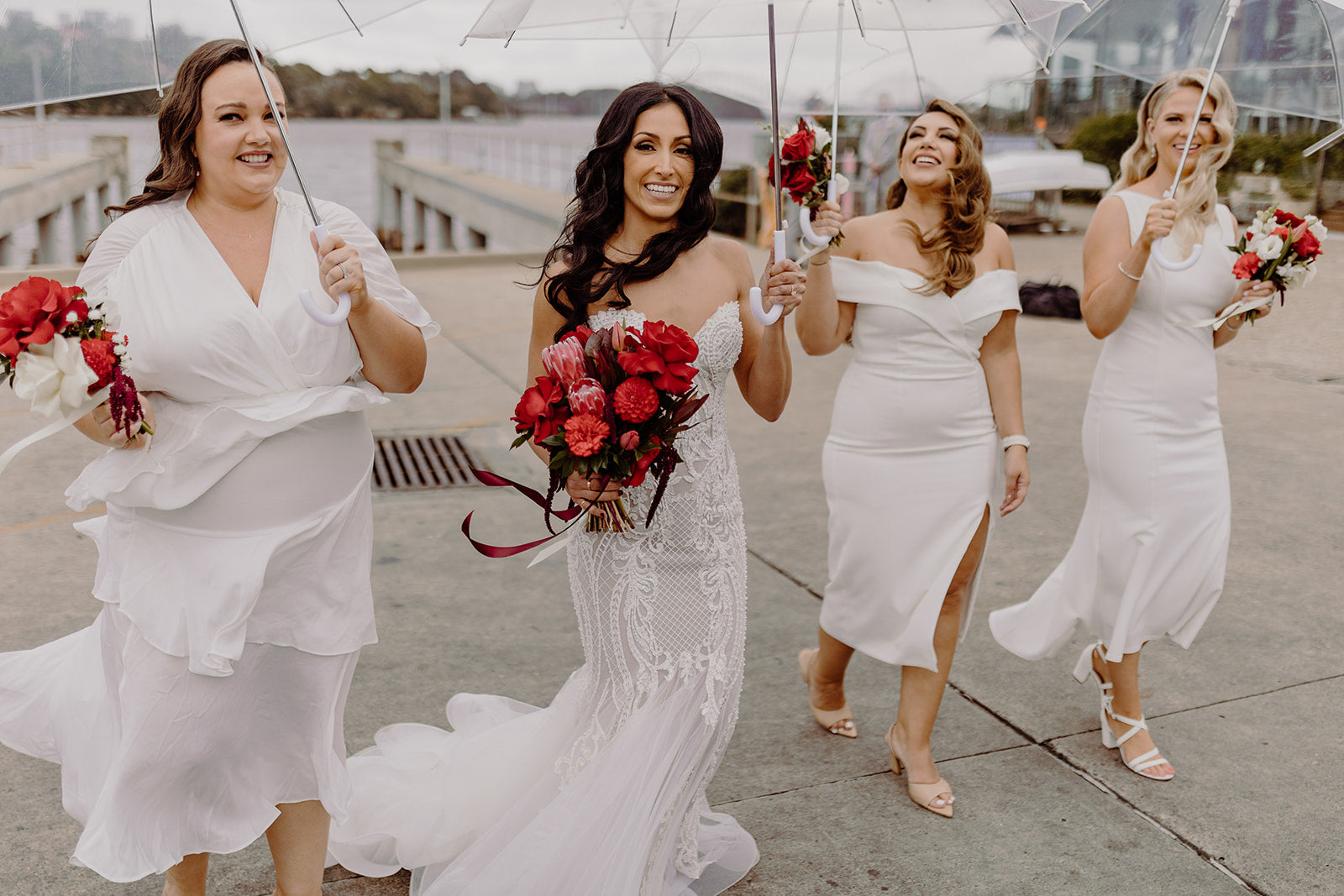 bride and bridesmaids with umbrellas wet wedding sydney