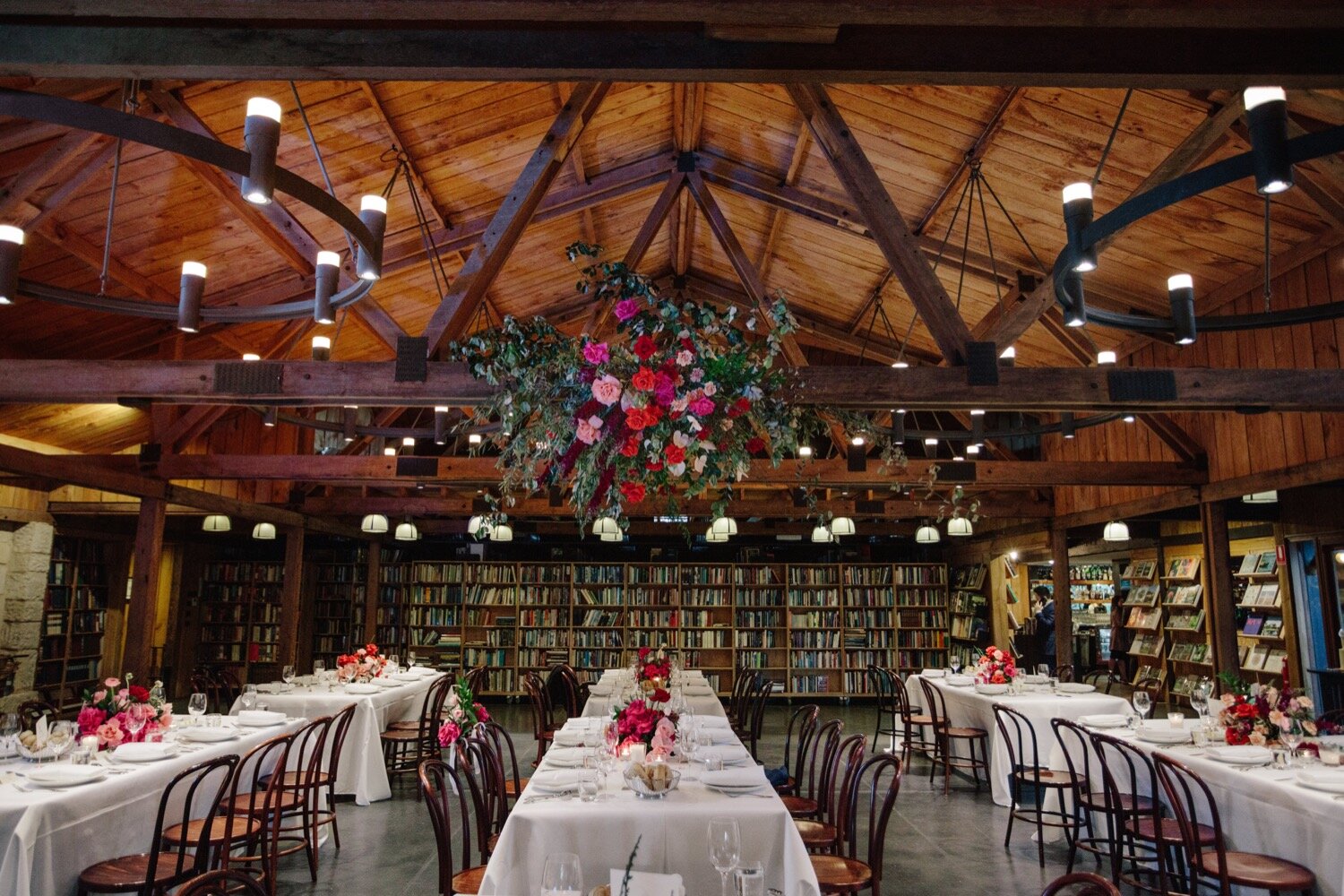indoor bendooley book barn wedding reception flowers and tables