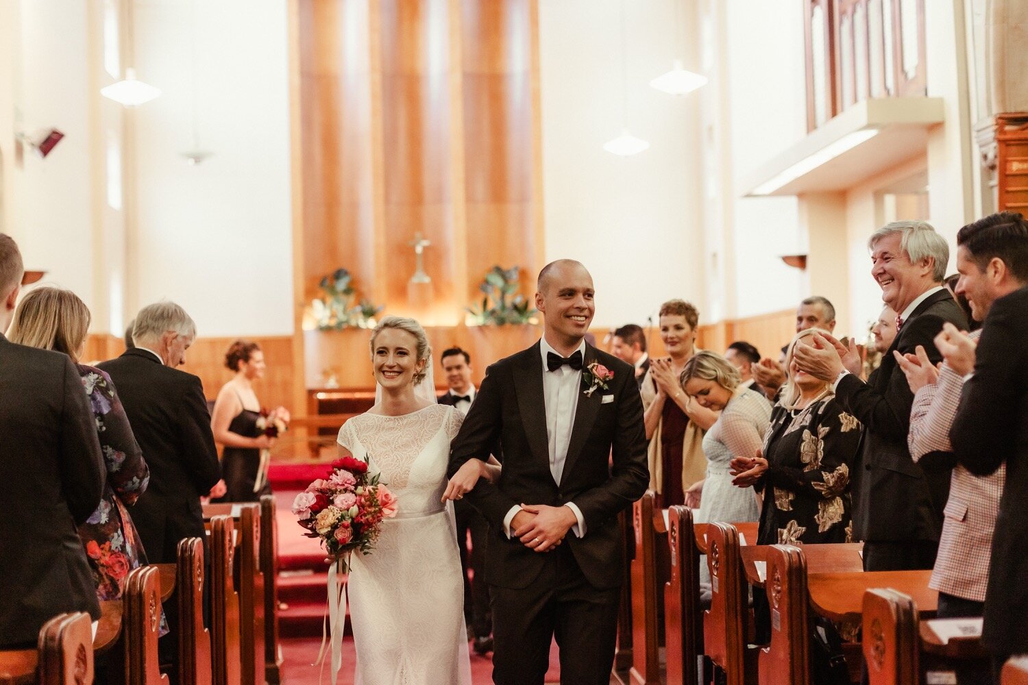 just married couple walking down church aisle sydney