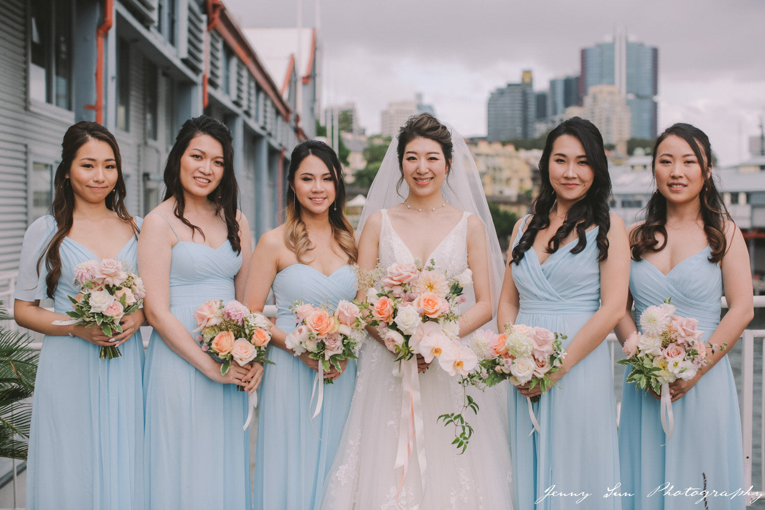 bride with bridesmaids in blue dresses and flowers pier one sydney wedding