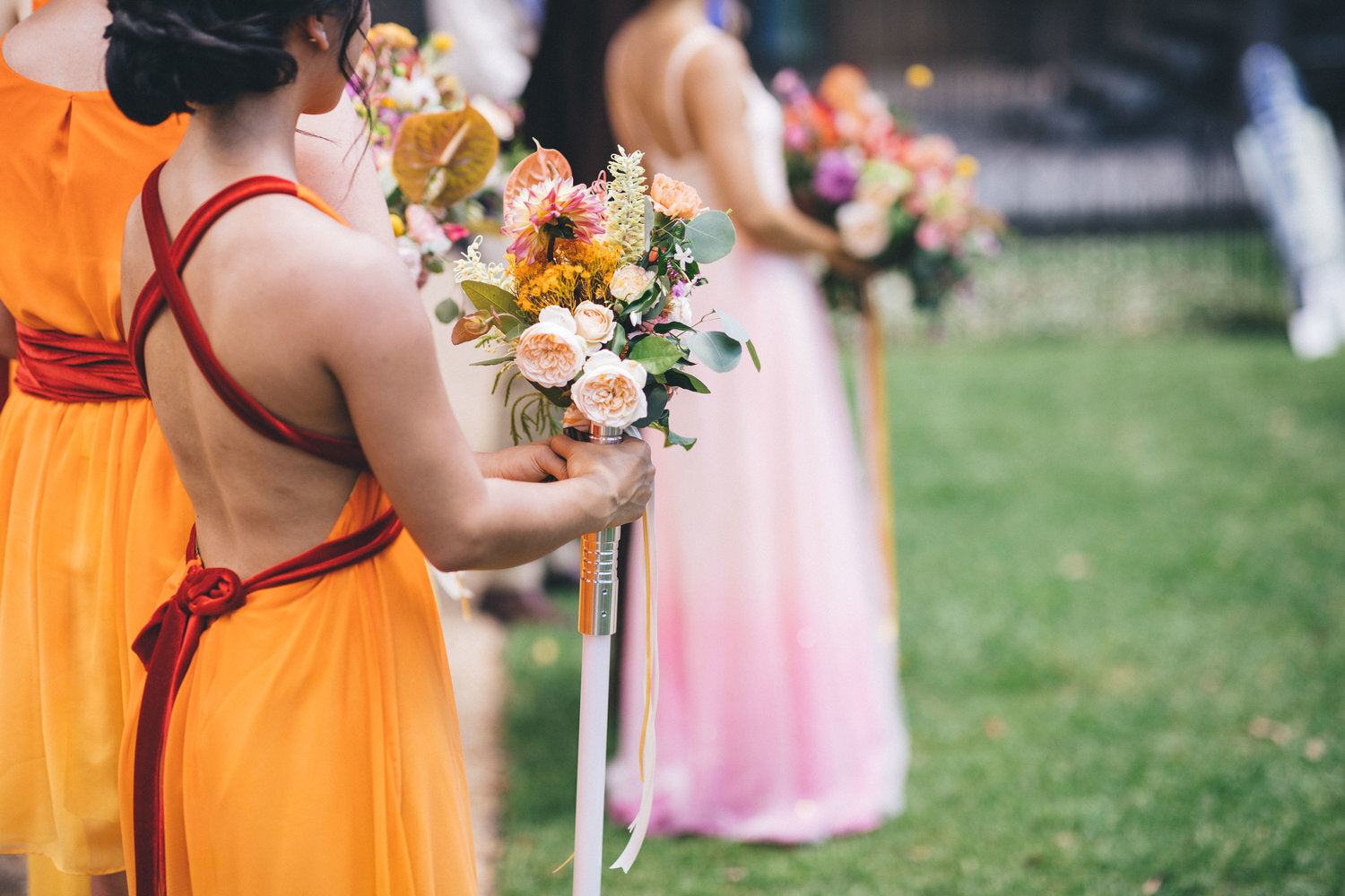 bridesmaid holding flowers and light sabre star wars wedding