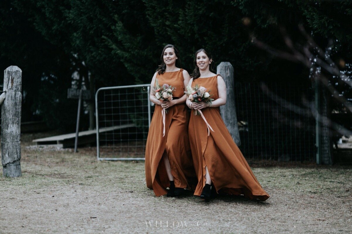bridesmaids with flowers in burnt orange dresses