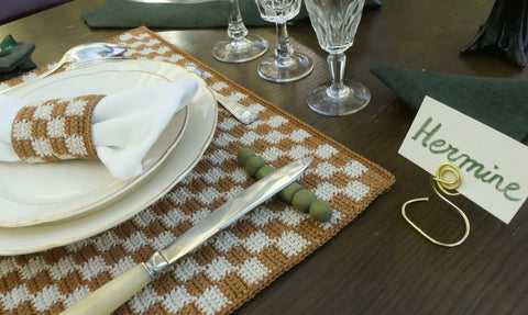 Checkerboard placemat in camel crochet and green clay knife pot