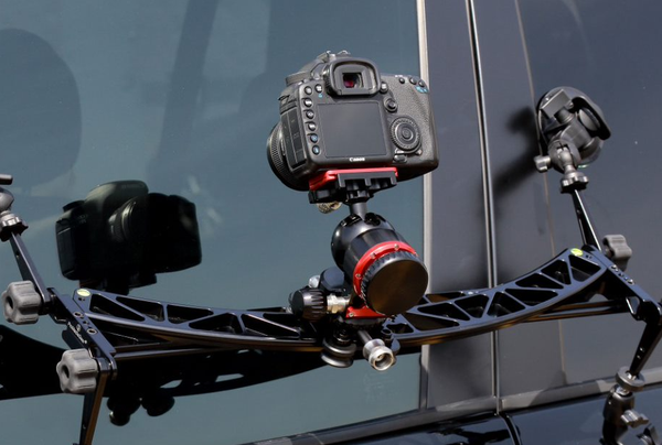 ProMediaGear dual track slider with DSLR mounted on a car