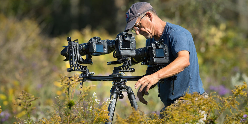 Three cameras mounted on a tripod