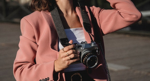 Woman in Pink Blazer Holding a Camera
