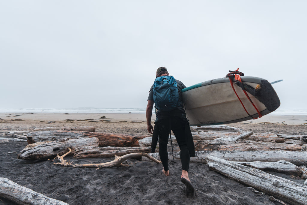 Preparing to surf at an overcast beach