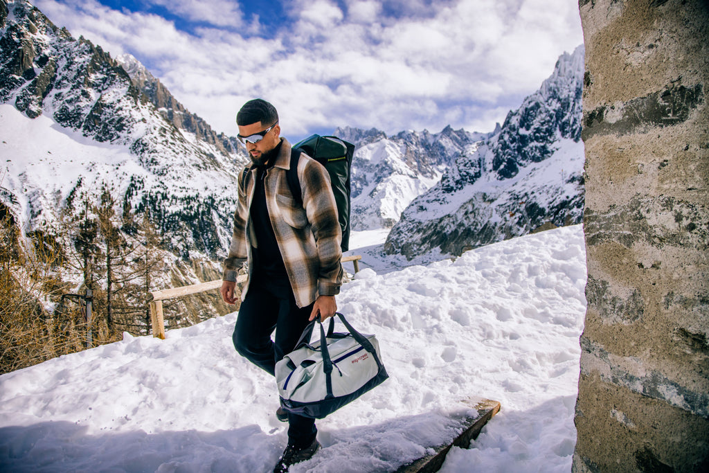 Walking through the snow with a duffel bag in Chamonix