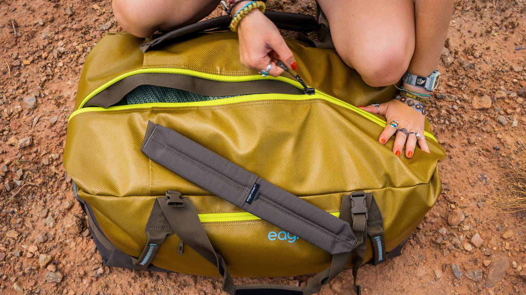 An Eagle Creek Migrate duffel bag in the sand