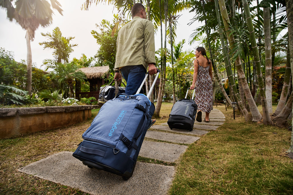 Rolling carry-on luggage through Hawaiian tropics