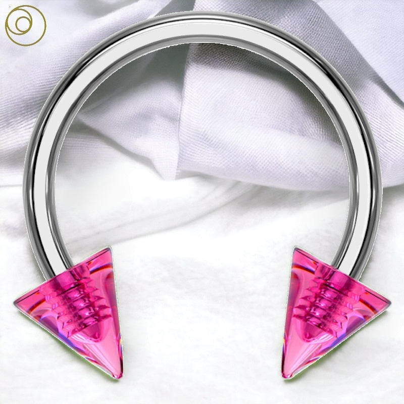A surgical steel 16g horseshoe nipple ring featuring pink spikes pictured against a white fabric background.
