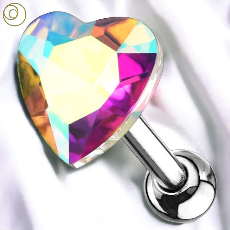 An aurora borealis crystal heart tragus earring in the center featuring a colorful aurora borealis crystal heart on the end of a surgical steel barbell with a ball on the end pictured against a white fabric background.