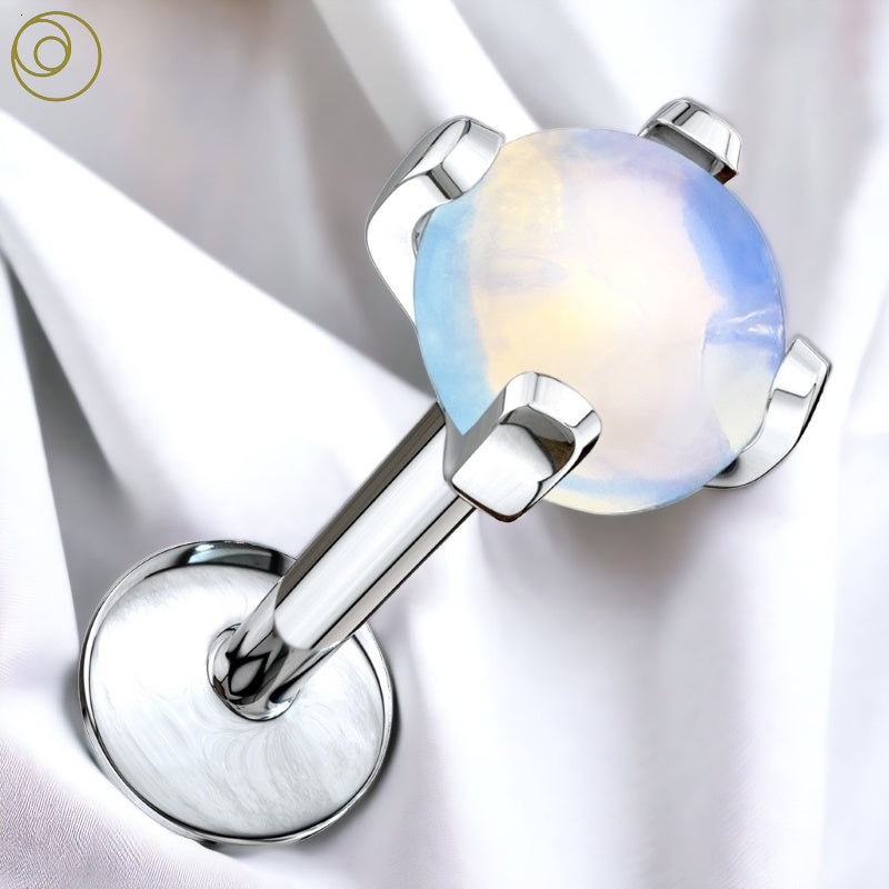 An opalite stone internally threaded labret with an opalite stone on a surgical steel bar pictured against a white fabric background.
