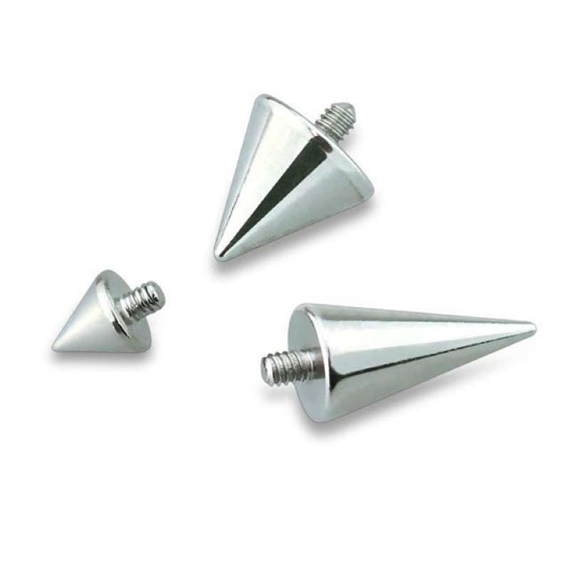 Three sizes of dermal top spikes laying randomly against a white background.
