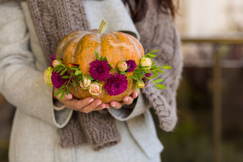 pumpkin with flowers around it
