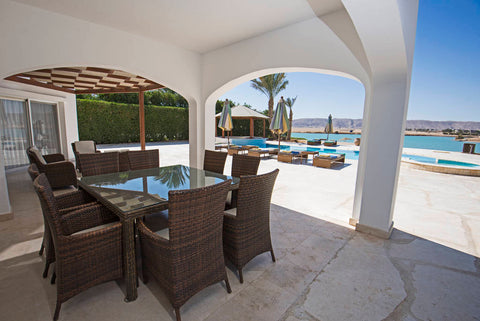 outdoor dining set and a view of a pool with more furniture