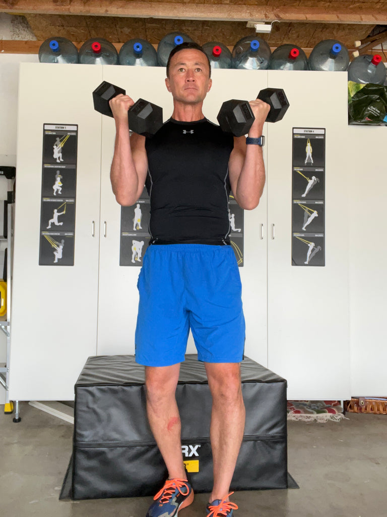 trainer doing dumbbell bicep curls