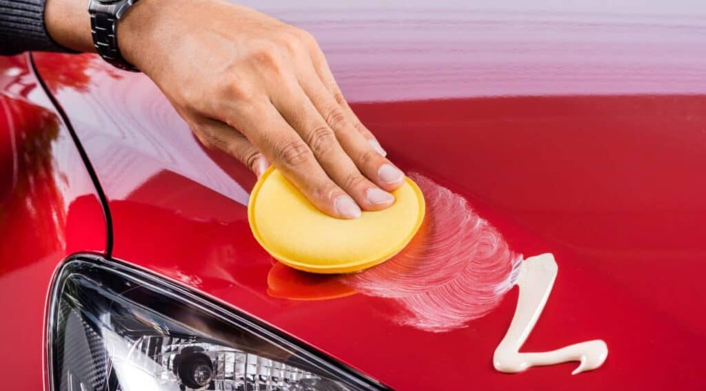 Second step in applying car wax is to apply the wet wax using a sponge