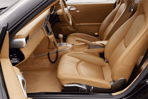 The interior of a sports car with tan leather seats.