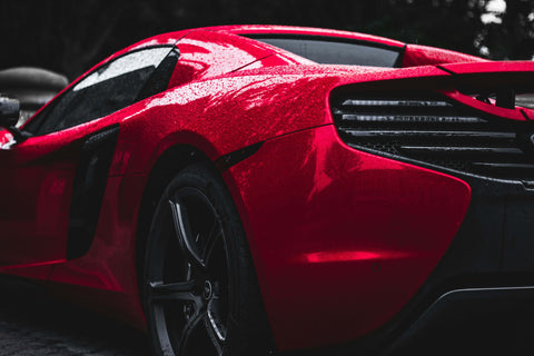 a red sports car parked on the side of the road