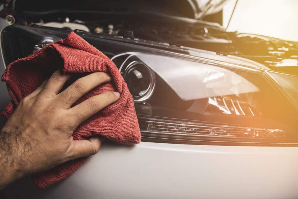 Buffing a car headlamp.