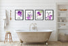 a display of 4 purple bathroom prints in the bathroom