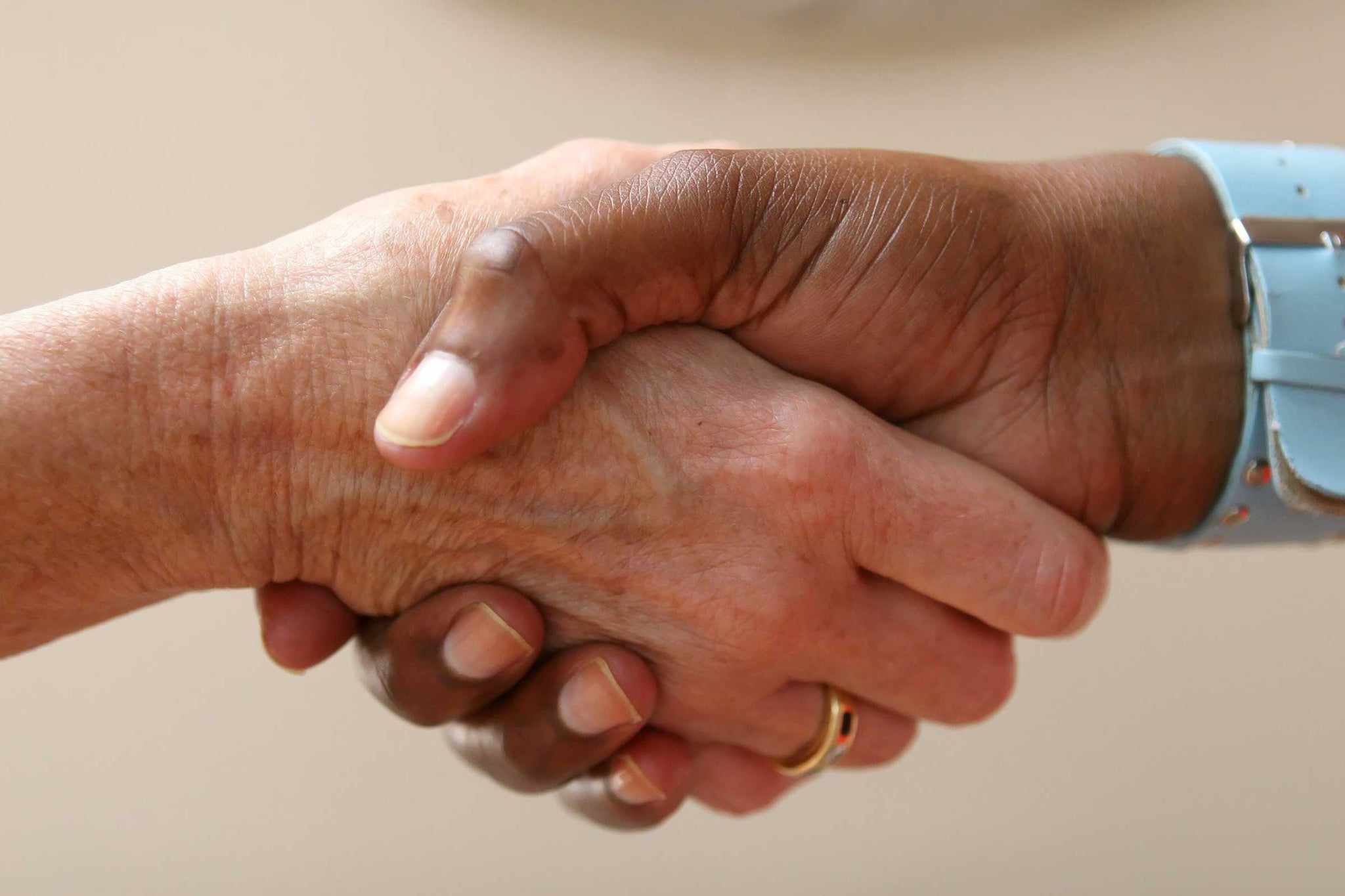 Business people shaking hands after signing lease agreement for space at Frisco Mercantile