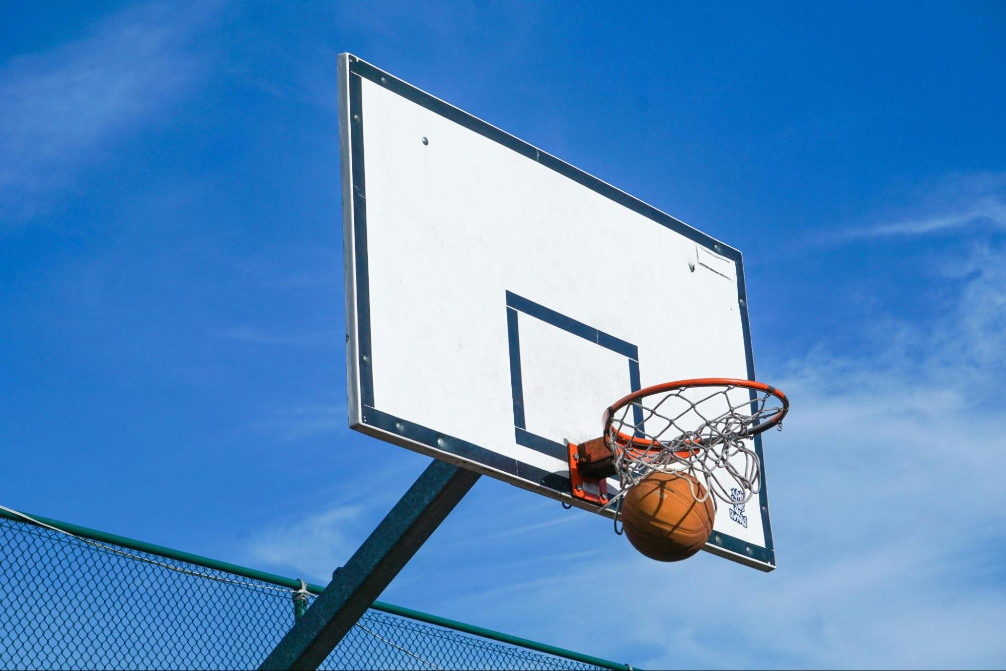 basketball going through an outdoor basketball hoop