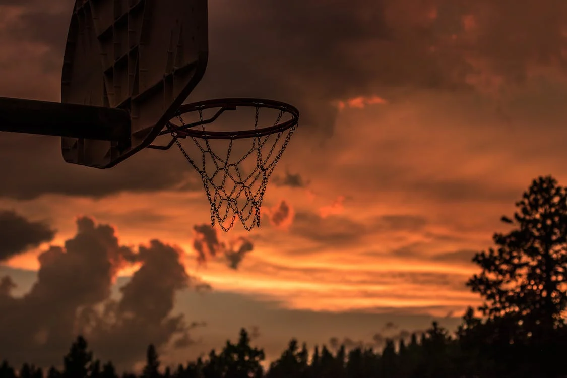 close-up of outdoor basketball hoop during sunset