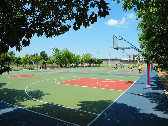 Outdoor basketball court with players
