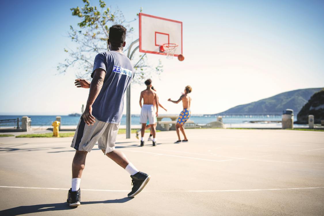 man shoots the ball in the 3-point line