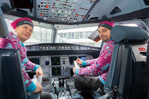 Eurowings pilots posing in custom pink and blue Christmas sweaters made by Roody sustainable swag