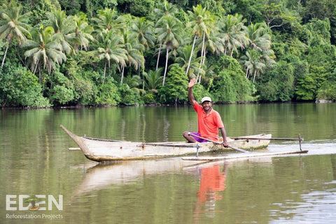 Man in boat 40,000 trees planted by Roody alongside Eden Reforestation Project