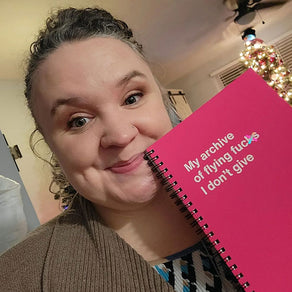 A woman posing with her Christmas gift: A WTF Notebook