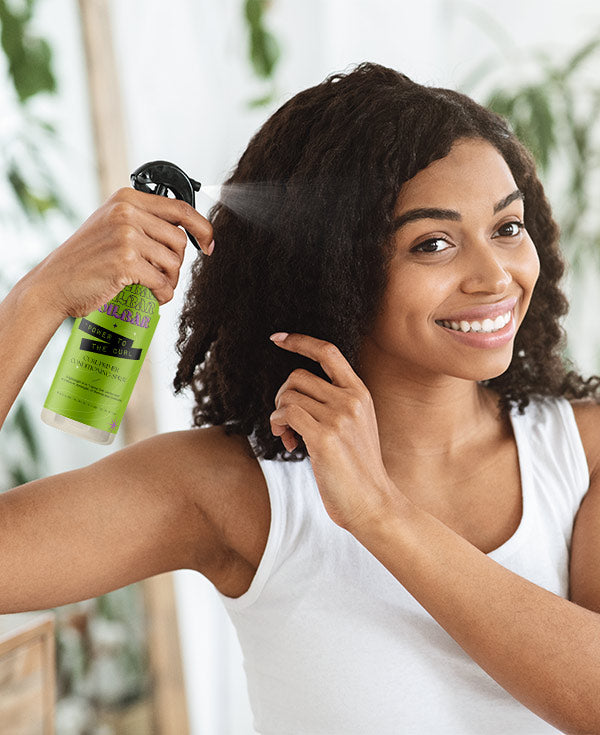 COILBAR Textured Haircare: woman spraying her type 3 curls with POWER TO THE CURL Curl Primer Conditioning Spray