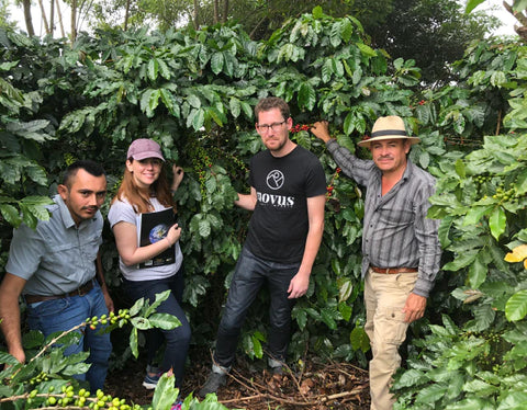 Mercon Specialty farm folks in front of coffee tree