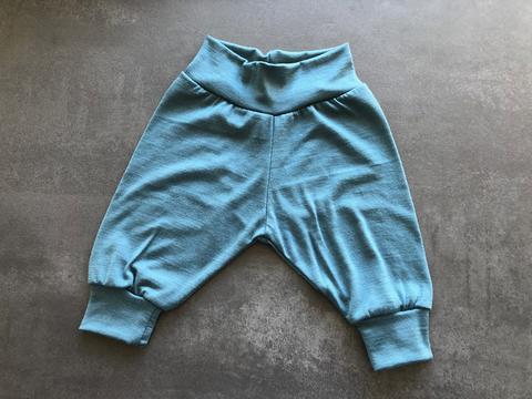 Flat lay of merino cuff trousers in Soft Teal.